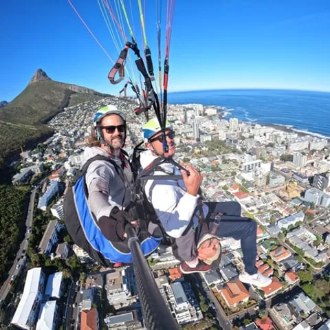 A tandem paraglider above the Cape Town city bowl