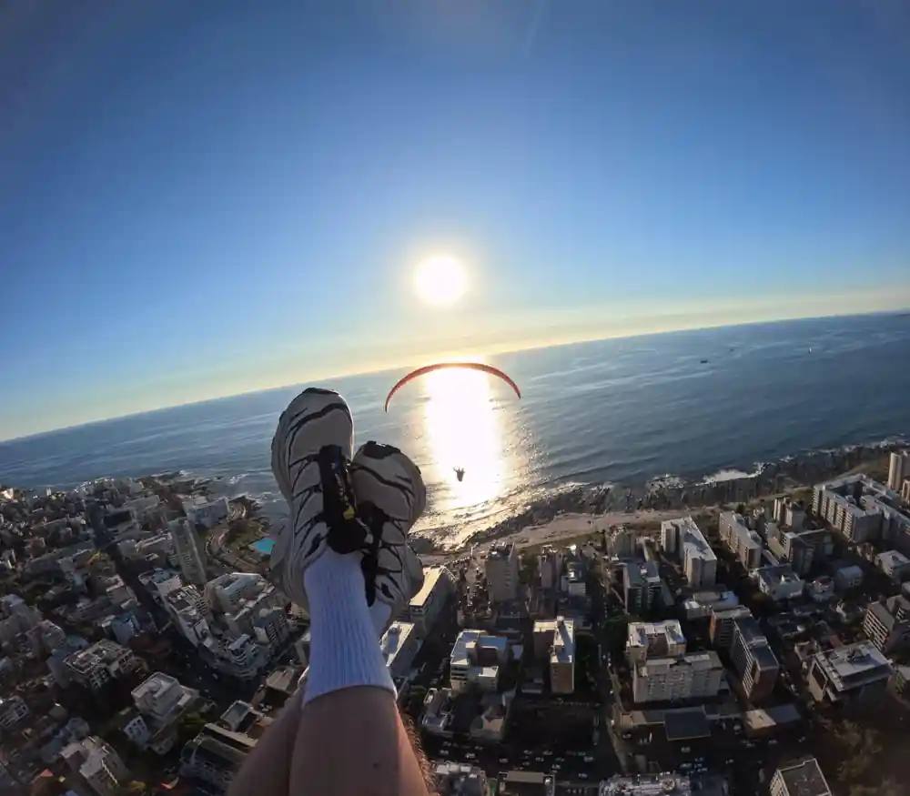 The sun low over the sea with the city below