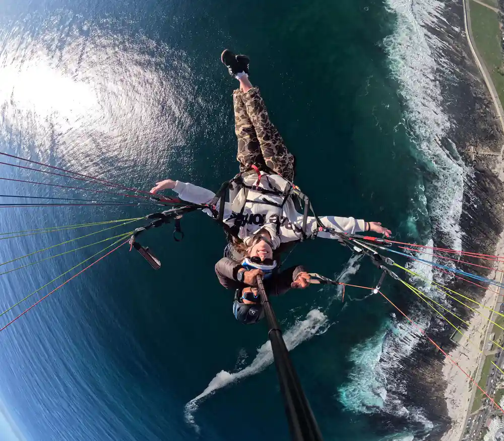 A tandem out over the surf and the rocks