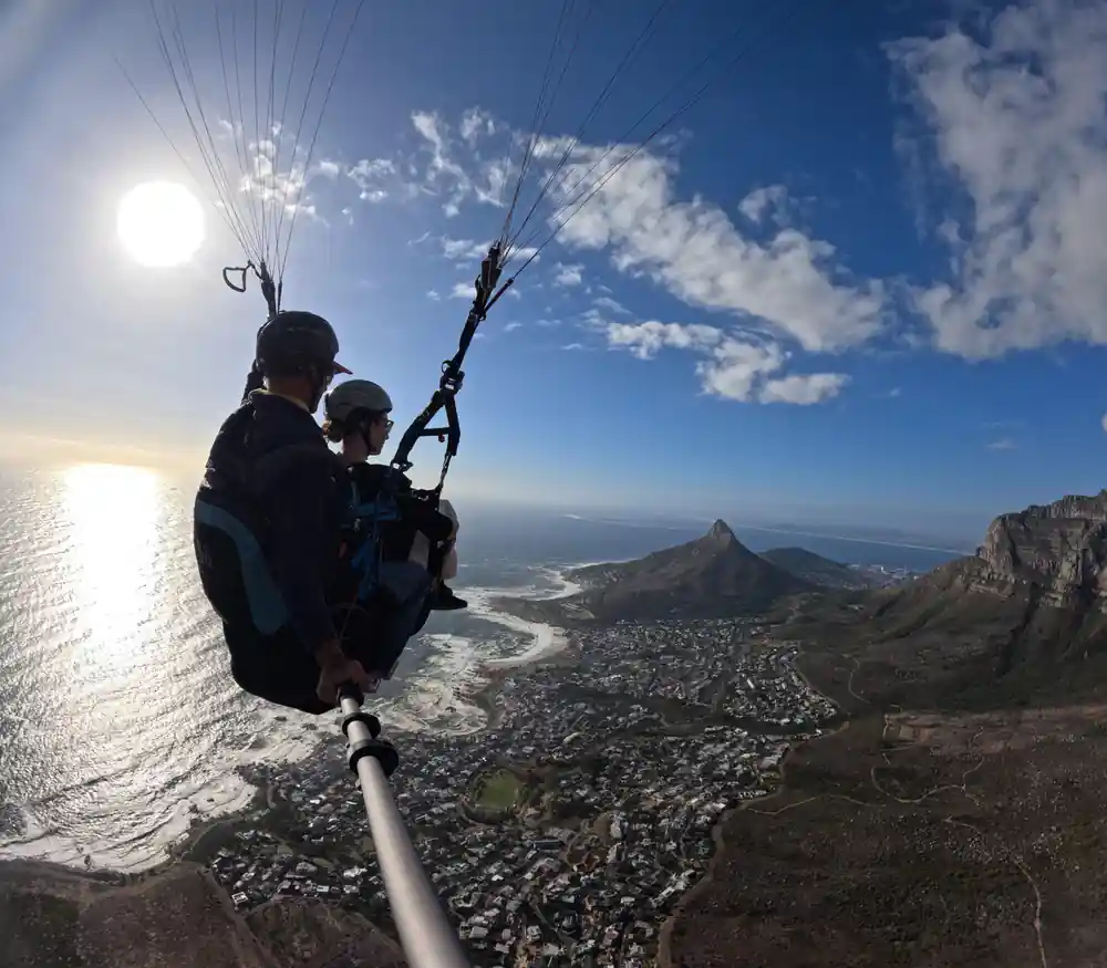 A tandem silhouetted with Lion’s Head and the coastline
